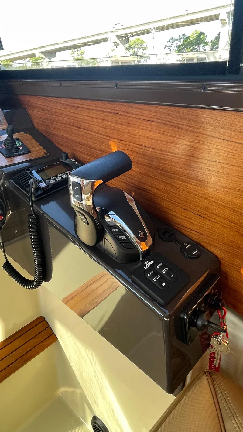 Slide: The Image of 2023 Ranger Tugs R-27 boat interior with control panel and throttle lever. - 46