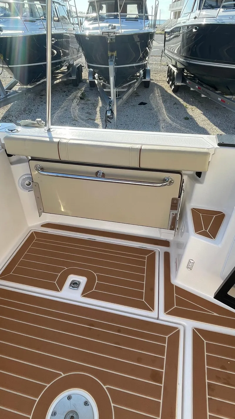 Slide: The Image of 2023 Ranger Tugs R-27 boat deck with teak-style flooring and sleek design. - 5