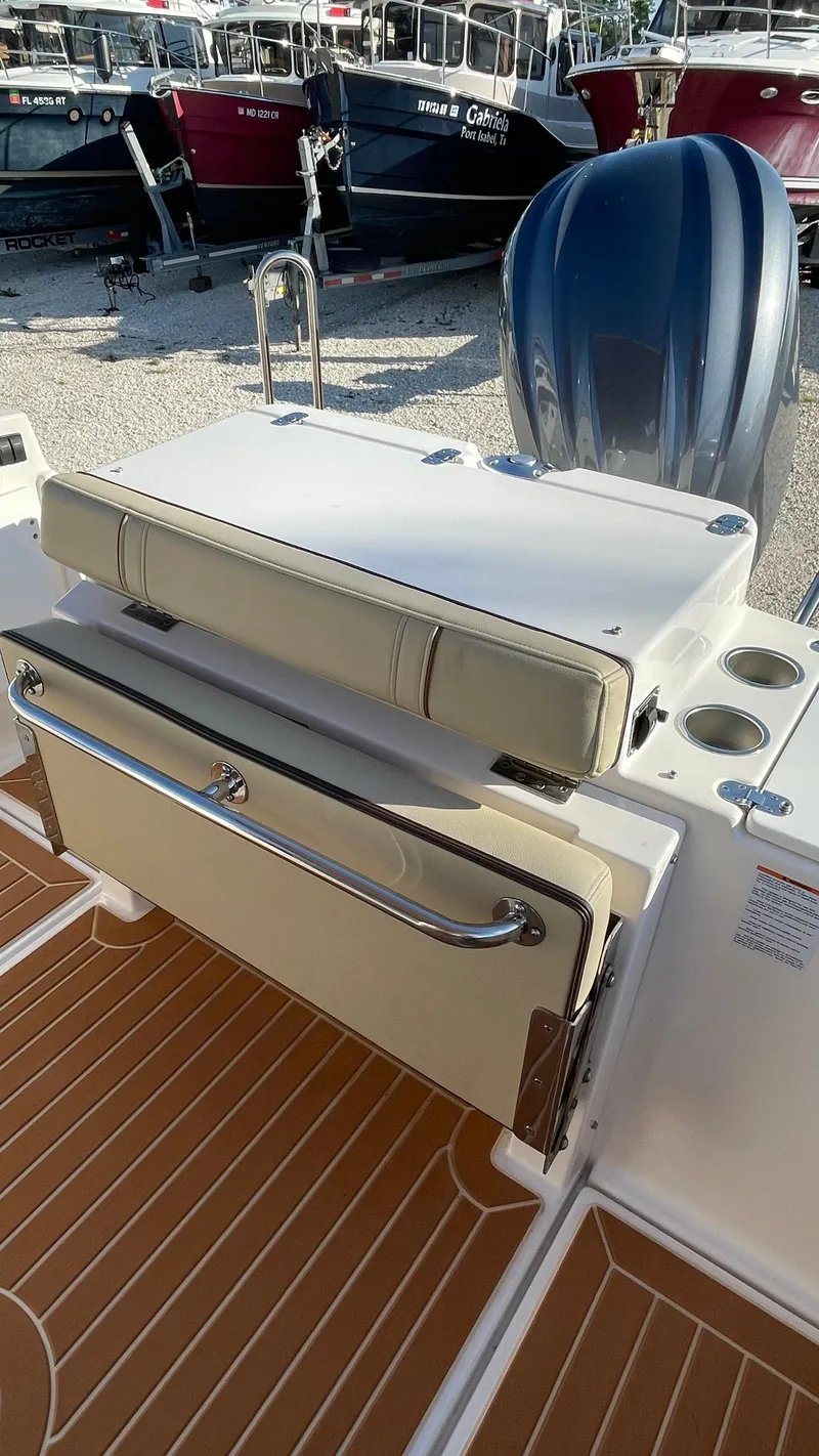 Slide: The Image of 2023 Ranger Tugs R-27 boat interior with seating and storage features. - 6