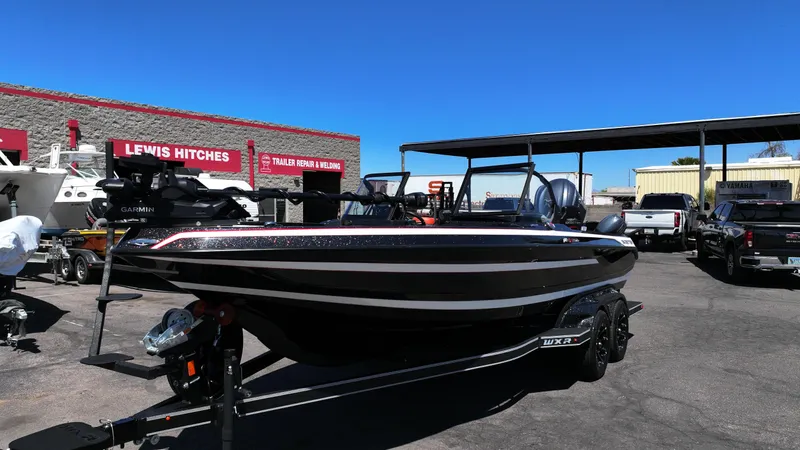 Slide: The Image of 2025 Skeeter WXR2260 boat on trailer in outdoor dealership lot. - 12