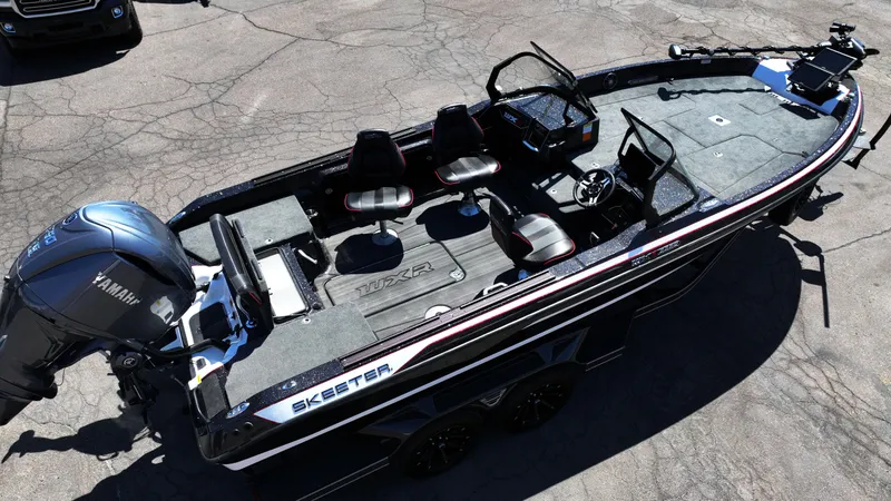 Slide: The Image of 2025 Skeeter WXR2260 fishing boat with Yamaha motor, featuring spacious seating and modern design. - 13