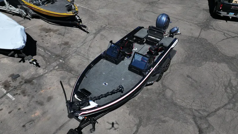 Slide: The Image of 2025 Skeeter WXR2260 fishing boat parked on concrete surface, featuring dual consoles and advanced electronics. - 14