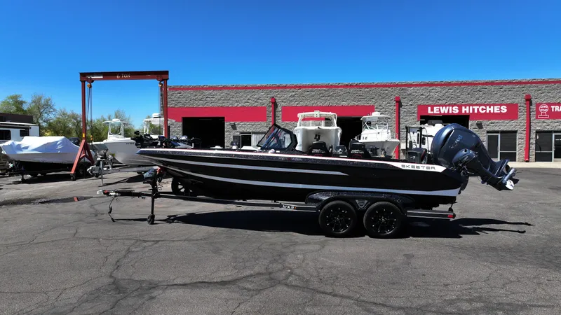 Slide: The Image of 2025 Skeeter WXR2260 boat on trailer at dealership, clear sky background. - 6