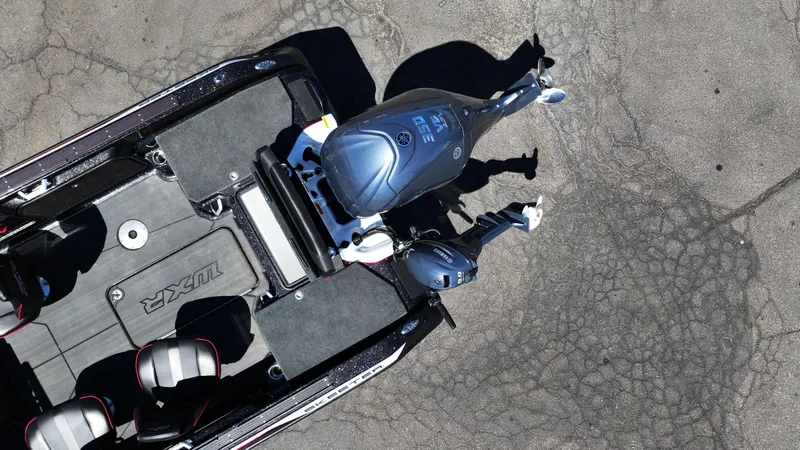 Slide: The Image of Aerial view of 2025 Skeeter WXR2260 boat with motor on cracked pavement. - 7