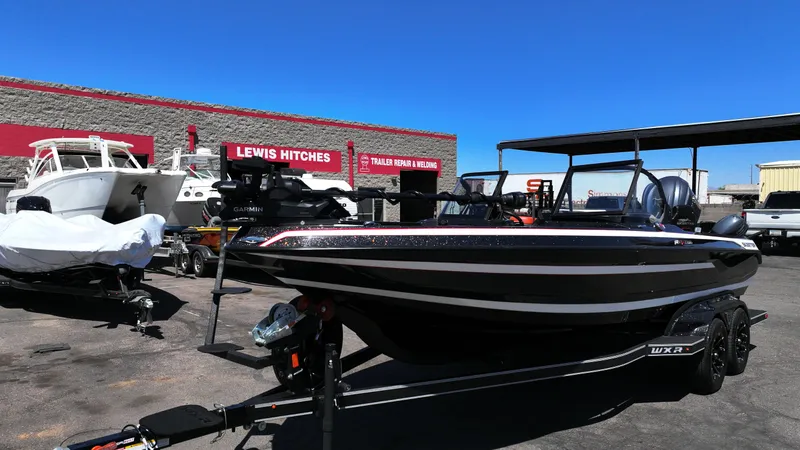 Slide: The Image of 2025 Skeeter WXR2260 boat on trailer at dealership, sunny day. - 8