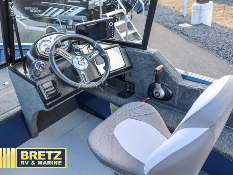 Slide: The Image of 2025 Excursion 176 DC boat cockpit with steering wheel and control panel. - 10
