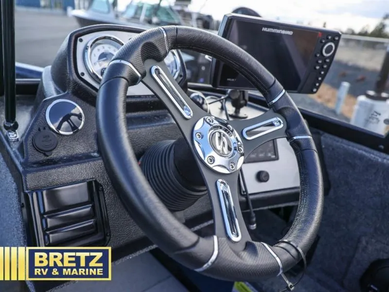 Slide: The Image of Steering wheel and dashboard of 2025 Excursion 176 DC boat with navigation system. - 11