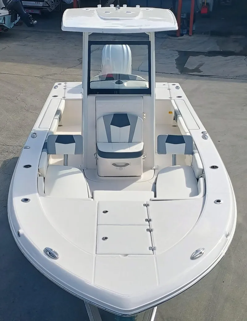 Slide: The Image of 2025 Robalo 246 Cayman boat, sleek design, spacious deck, white exterior. - 2