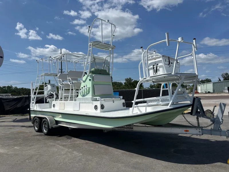 Slide: The Image of 2023 Shallow Master 240 SMS boat on trailer under blue sky. - 0