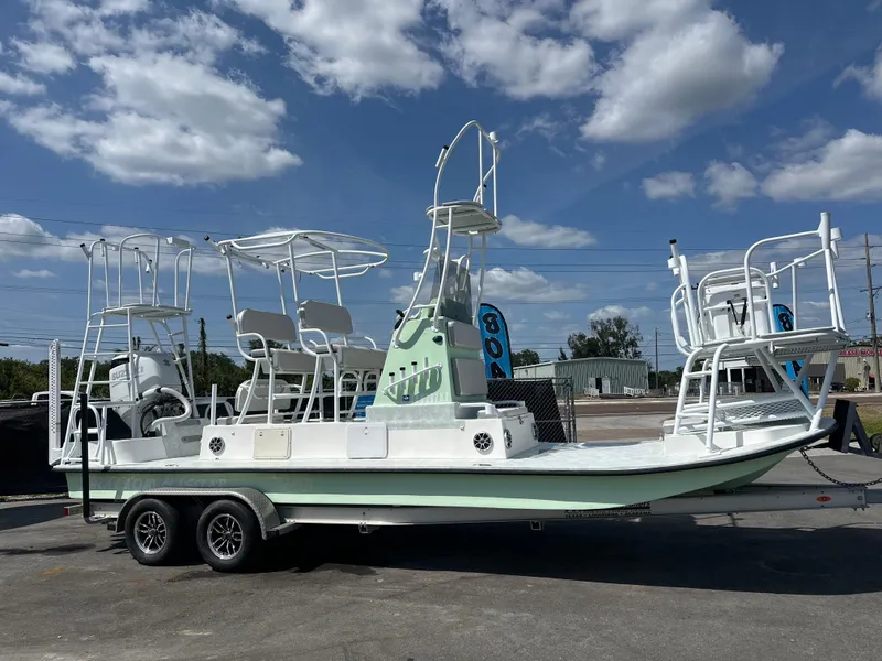 Slide: The Image of 2023 Shallow Master 240 SMS boat on trailer under blue sky. - 1