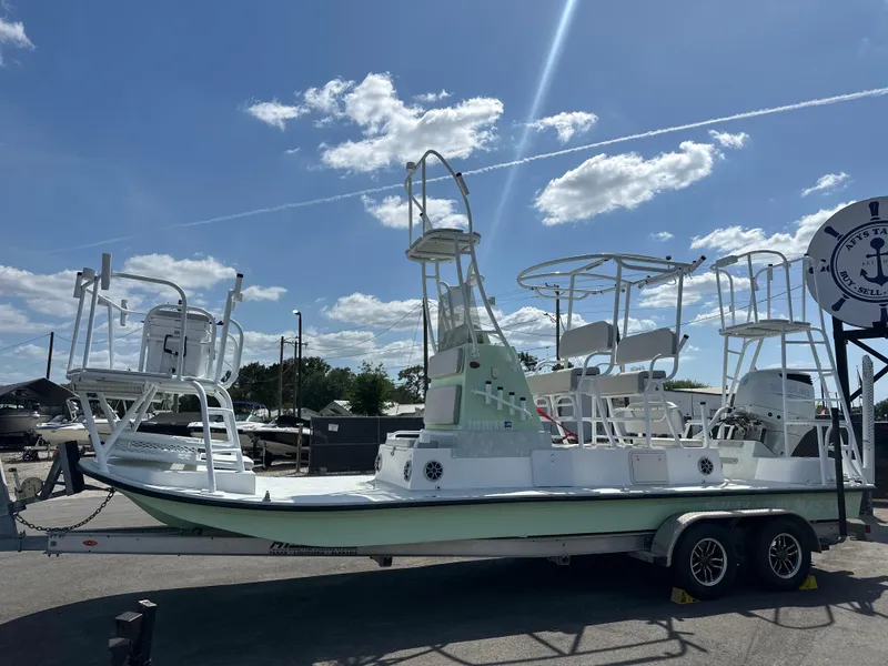 Slide: The Image of 2023 Shallow Master 240 SMS boat on trailer under clear blue sky. - 10