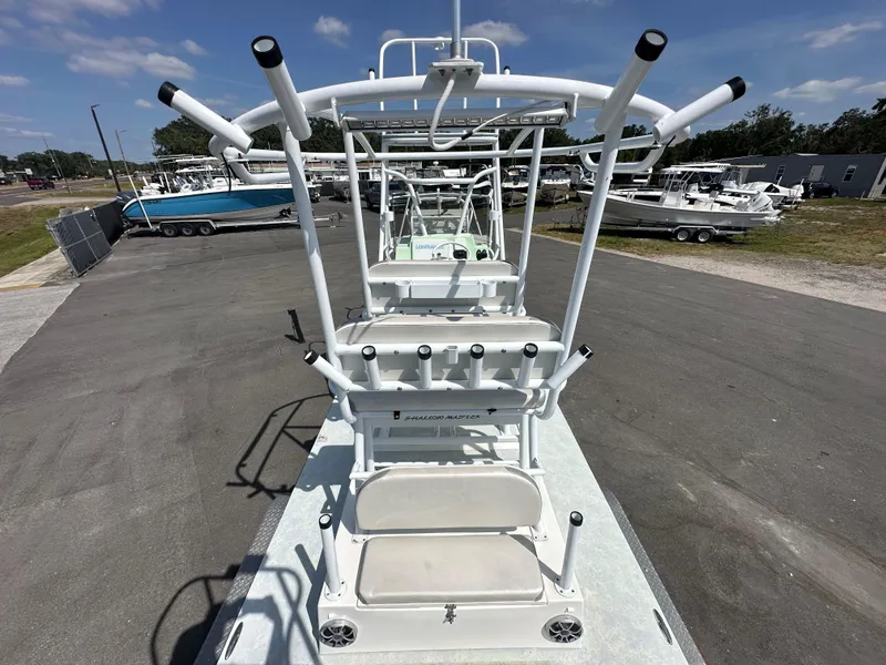 Slide: The Image of Shallow Master 240 SMS 2023 boat with rod holders and T-top in a marina. - 15