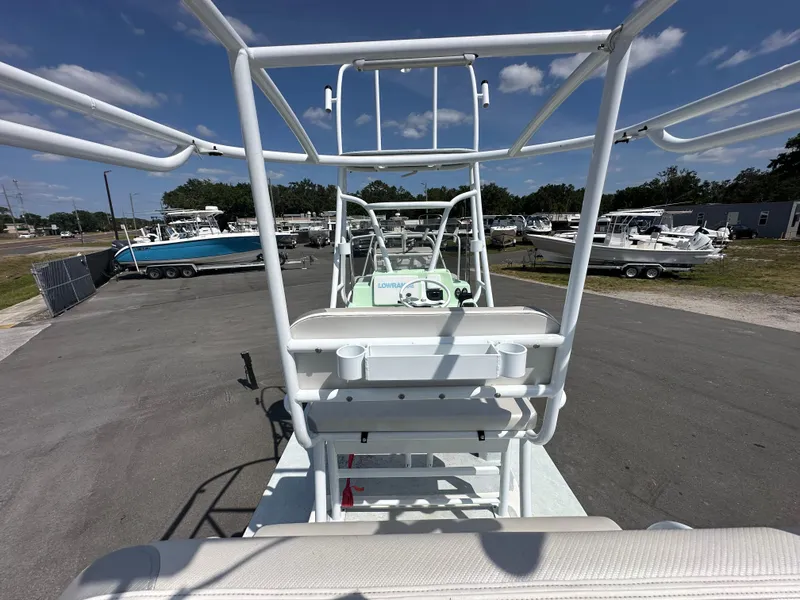 Slide: The Image of 2023 Shallow Master 240 SMS boat in a marina, surrounded by other vessels under a clear sky. - 17