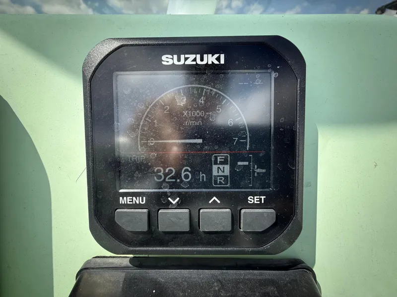 Slide: The Image of Digital display on a 2023 Shallow Master 240 SMS boat showing engine hours and settings. - 20