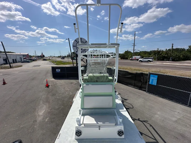 Slide: The Image of 2023 Shallow Master 240 SMS boat on display under a clear blue sky. - 23