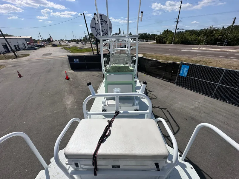 Slide: The Image of 2023 Shallow Master 240 SMS boat on a paved lot under a clear sky. - 24