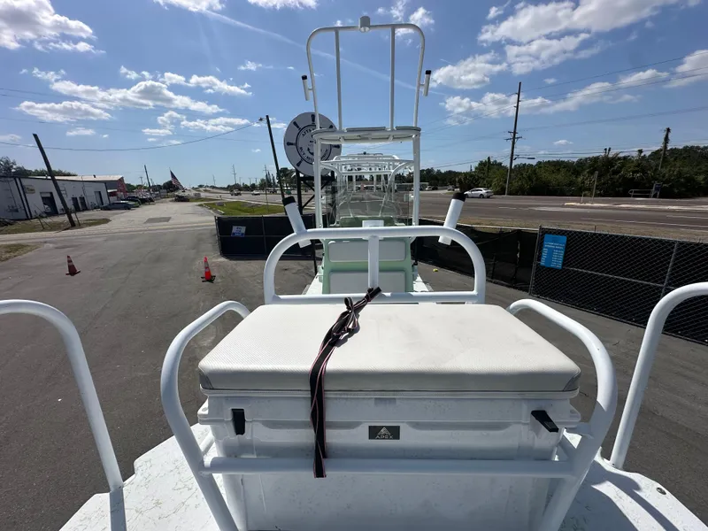 Slide: The Image of Shallow Master 240 SMS boat, 2023 model, parked outdoors under a clear blue sky. - 25