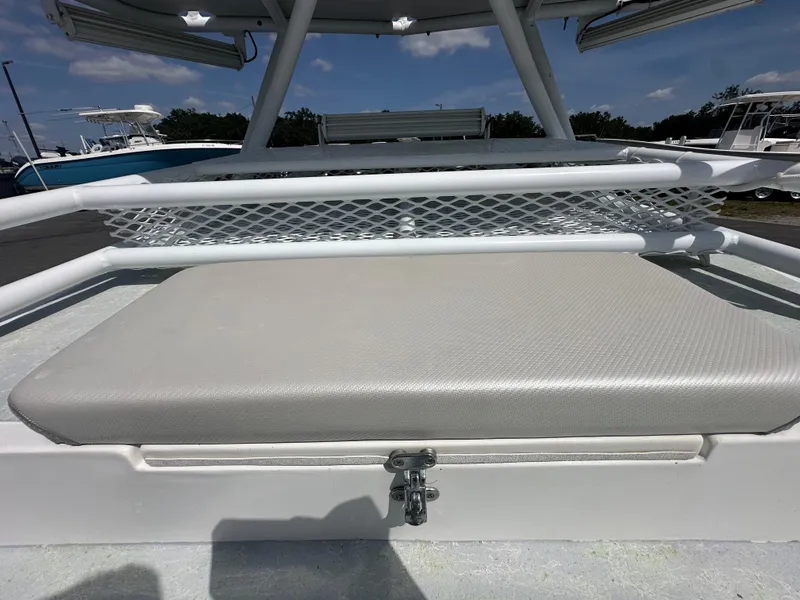Slide: The Image of 2023 Shallow Master 240 SMS boat with cushioned seating and storage compartment. - 27