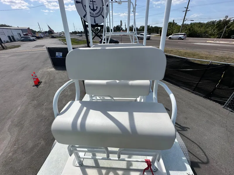 Slide: The Image of White seating on 2023 Shallow Master 240 SMS boat, outdoor setting, sunny day. - 29