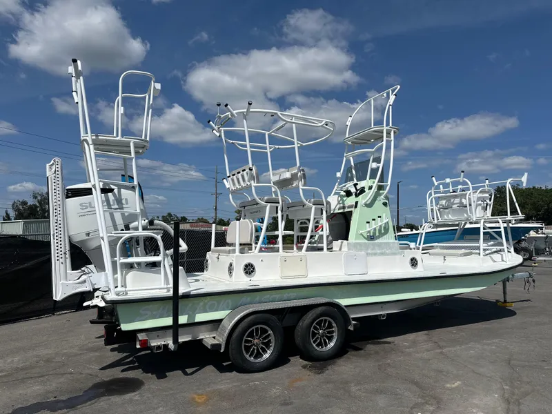 Slide: The Image of 2023 Shallow Master 240 SMS boat on trailer under blue sky. - 3
