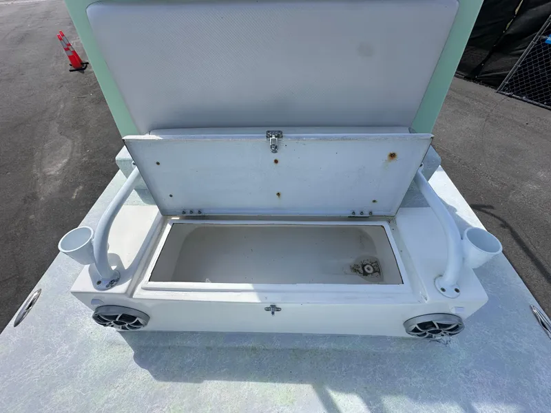 Slide: The Image of Open storage compartment on Shallow Master 240 SMS boat, 2023 model, with rod holders and speakers. - 32
