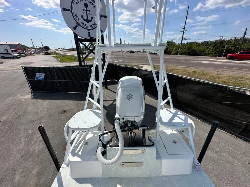 Slide: The Image of 2023 Shallow Master 240 SMS boat with outboard motor, docked under clear sky. - 34