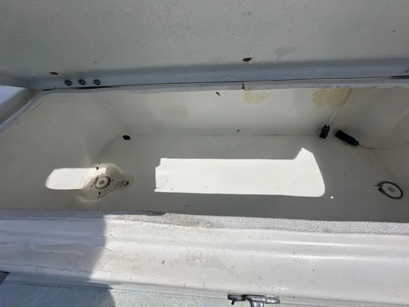 Slide: The Image of Open storage compartment of 2023 Shallow Master 240 SMS boat, showing interior details. - 37