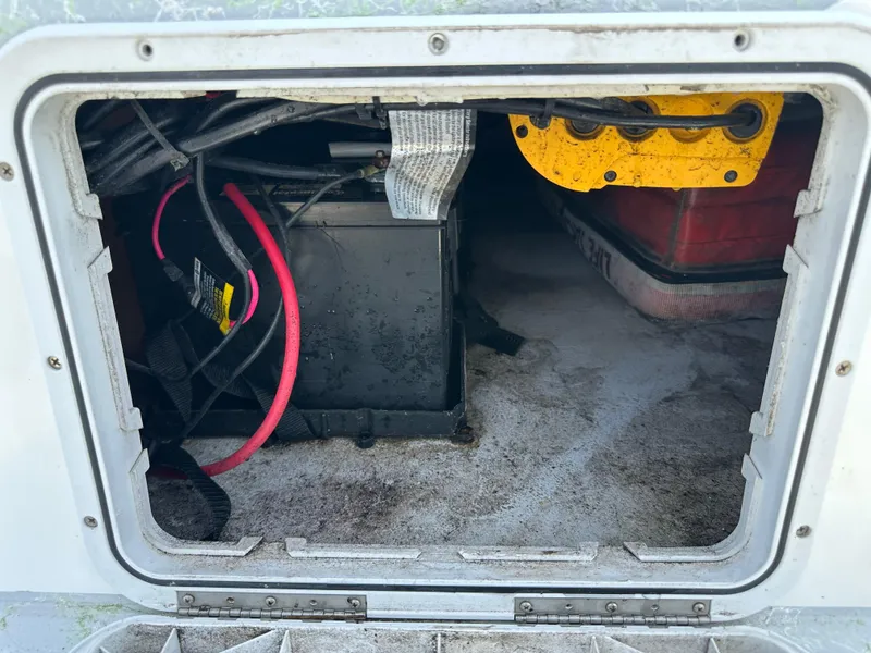 Slide: The Image of Battery compartment of 2023 Shallow Master 240 SMS boat, featuring cables and storage space. - 42