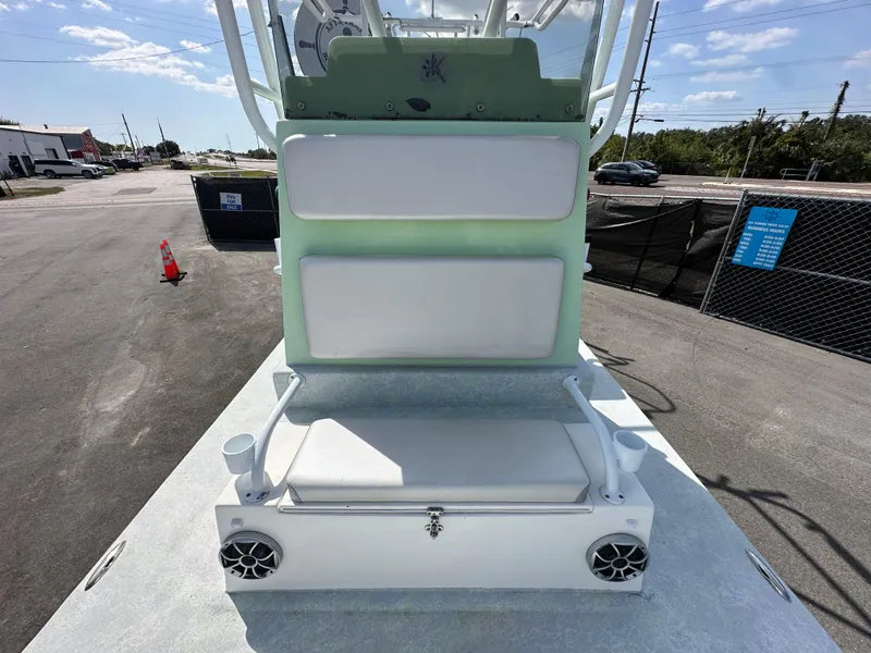Slide: The Image of 2023 Shallow Master 240 SMS boat with seating and speakers, parked outdoors. - 44