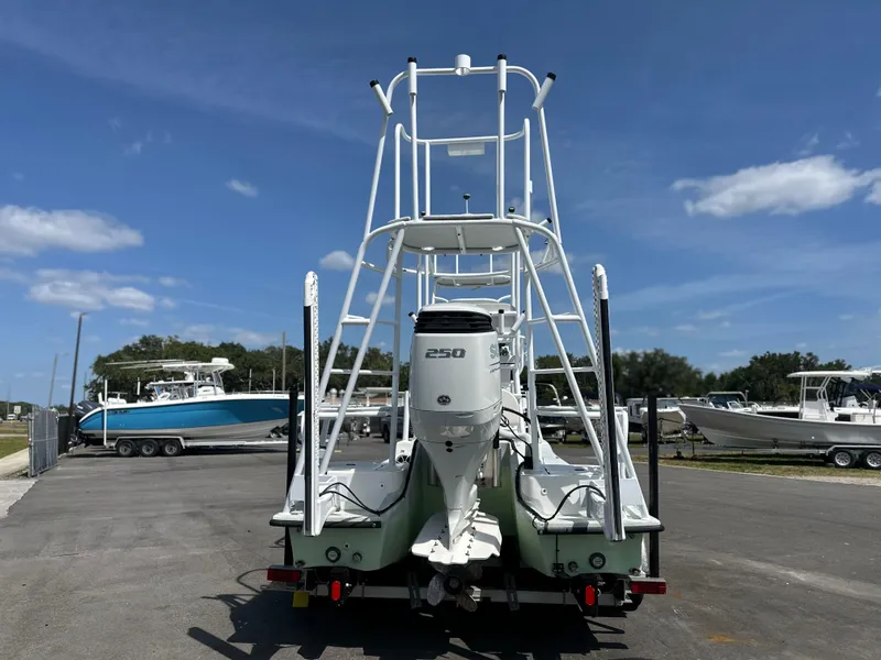 Slide: The Image of 2023 Shallow Master 240 SMS boat with 250 HP engine, parked on a sunny day. - 8