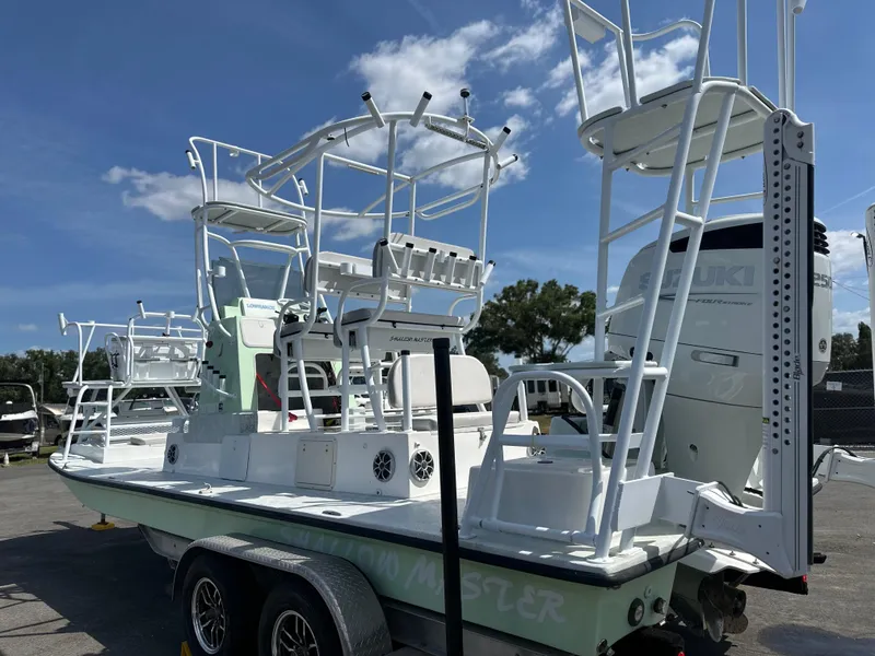Slide: The Image of 2023 Shallow Master 240 SMS boat on trailer under clear sky. - 9
