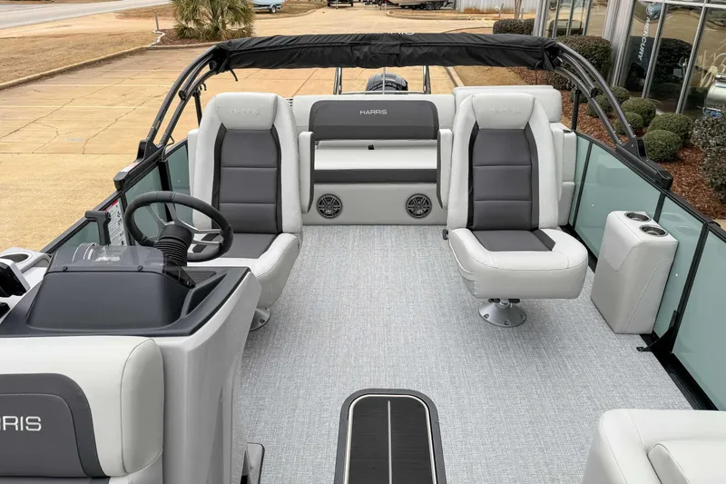 Slide: The Image of 2025 Harris CRUISER 230 SLDH pontoon boat interior with modern seating and steering console. - 16