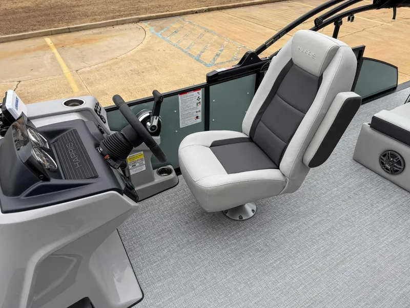 Slide: The Image of Captain's seat and helm of 2025 Harris CRUISER 230 SLDH boat, featuring modern controls. - 18