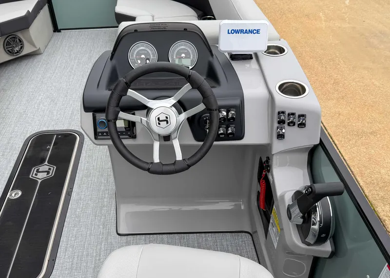 Slide: The Image of 2025 Harris CRUISER 230 SLDH boat dashboard with steering wheel and controls. - 19