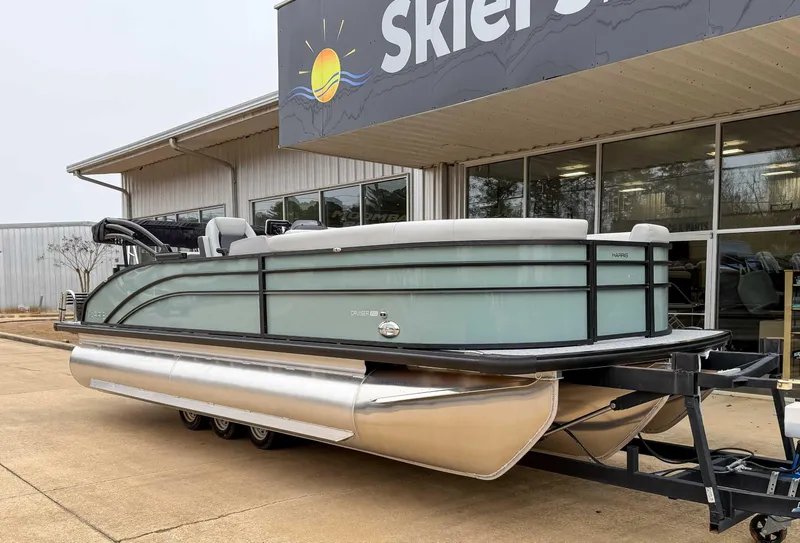 Slide: The Image of 2025 Harris CRUISER 230 SLDH pontoon boat displayed outside dealership. - 3
