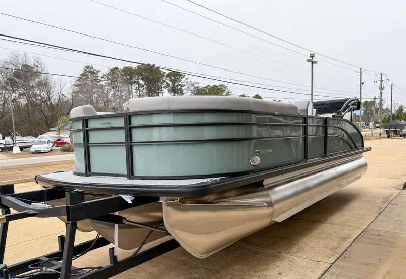 Slide: The Image of 2025 Harris CRUISER 230 SLDH pontoon boat on trailer, parked outdoors. - 5