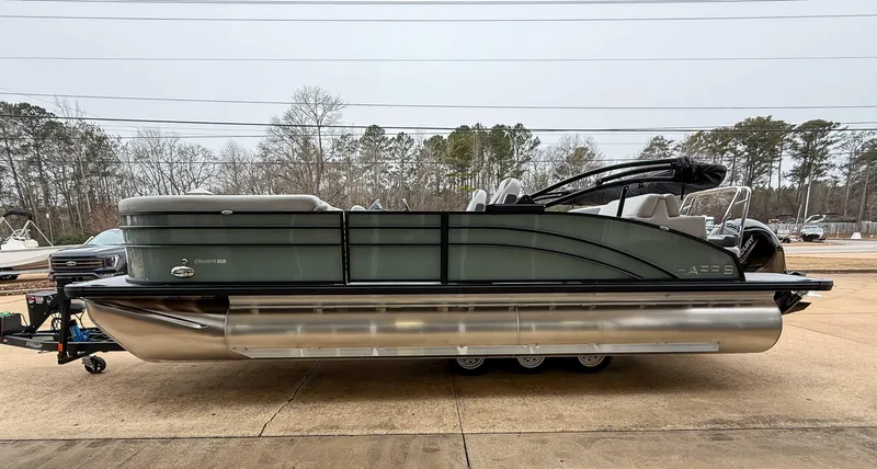 Slide: The Image of 2025 Harris CRUISER 230 SLDH pontoon boat parked outdoors, side view. - 6