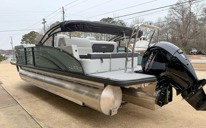 Slide: The Image of 2025 Harris CRUISER 230 SLDH pontoon boat with Mercury outboard motor, docked outdoors. - 7