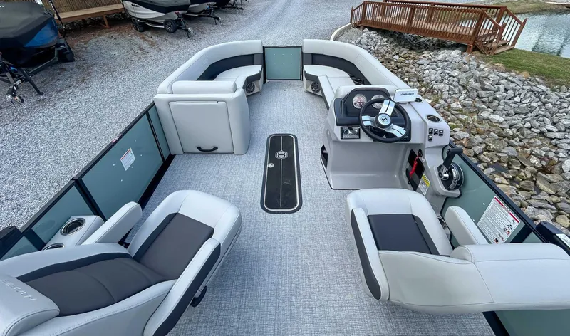 Slide: The Image of 2025 Harris CRUISER 230 SLDH pontoon boat interior with modern seating and steering console. - 11
