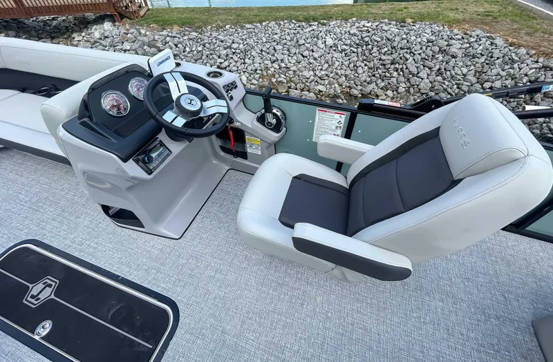 Slide: The Image of 2025 Harris CRUISER 230 SLDH boat interior with steering console and captain's chair. - 15