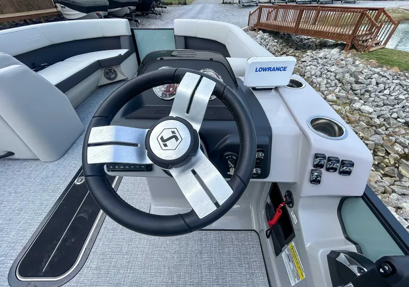Slide: The Image of 2025 Harris CRUISER 230 SLDH boat interior with steering wheel and control panel. - 16