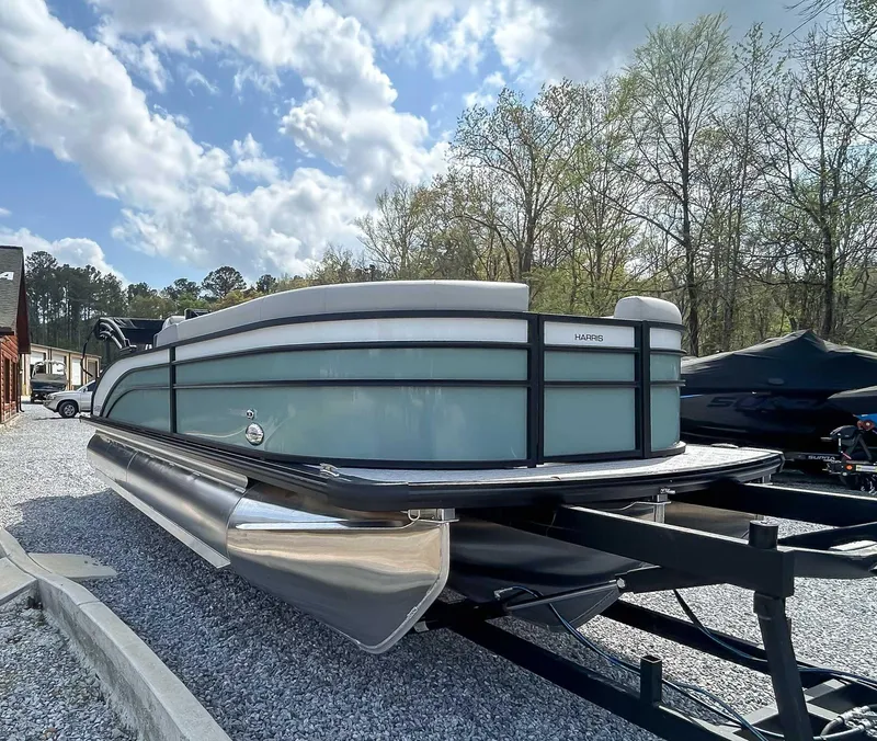 Slide: The Image of 2025 Harris CRUISER 230 SLDH pontoon boat on trailer, parked outdoors. - 5