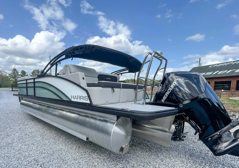 Slide: The Image of 2025 Harris CRUISER 230 SLDH pontoon boat with Mercury engine on gravel lot. - 8