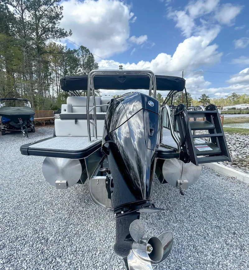 Slide: The Image of 2025 Harris CRUISER 230 SLDH pontoon boat with outboard motor, parked on gravel. - 9