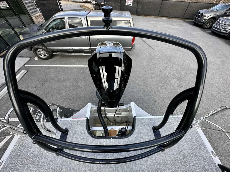 Slide: The Image of 2024 Premier 250 Solaris RL boat with powerful outboard motor, parked near trucks. - 11