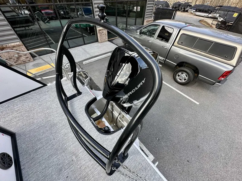 Slide: The Image of 2024 Premier 250 Solaris RL boat with Mercury engine, parked near a silver truck. - 12