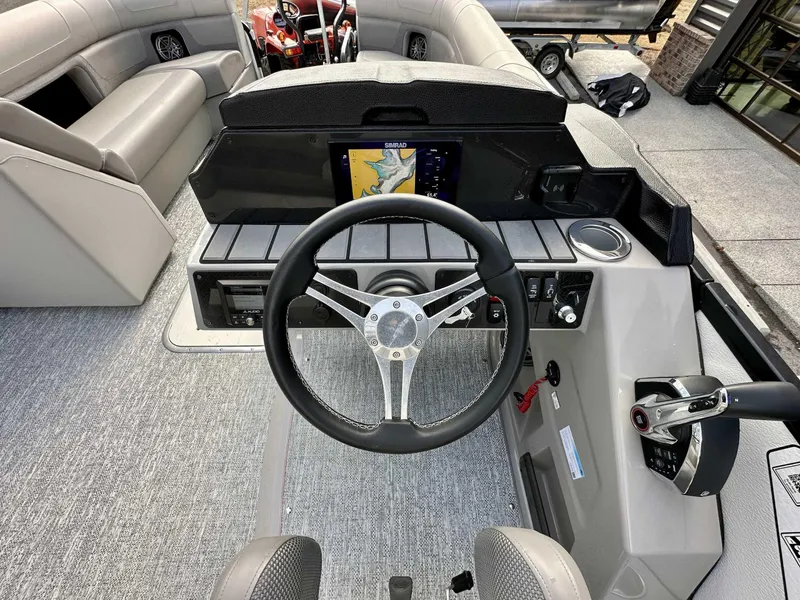 Slide: The Image of 2024 Premier 250 Solaris RL boat dashboard with steering wheel and navigation display. - 17