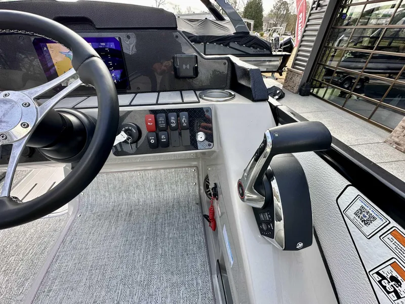 Slide: The Image of 2024 Premier 250 Solaris RL boat dashboard with steering wheel and control panel. - 18