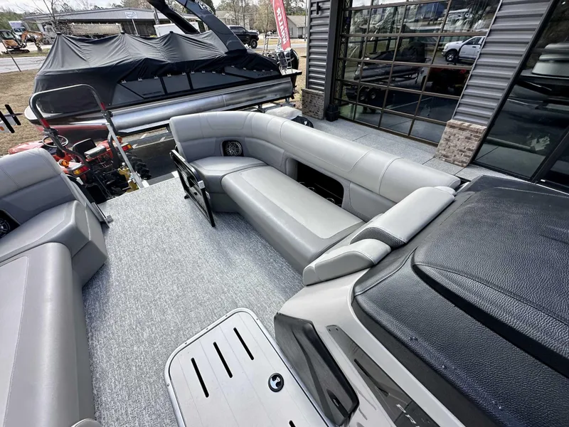 Slide: The Image of 2024 Premier 250 Solaris RL pontoon boat interior with gray seating and modern design. - 21
