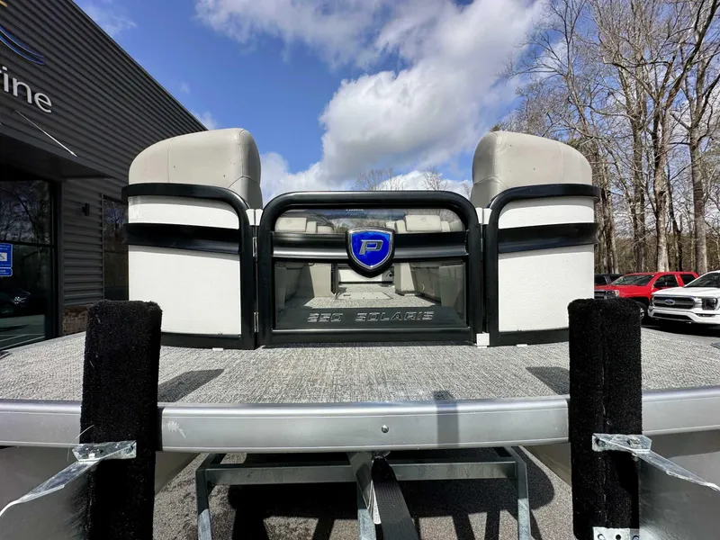 Slide: The Image of 2024 Premier 250 Solaris RL pontoon boat on trailer, dealership background. - 3